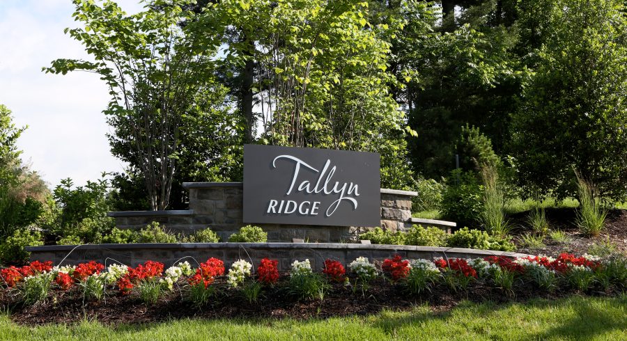 A picturesque view of the Tallyn Ridge entrance sign set amidst a beautifully landscaped backdrop.