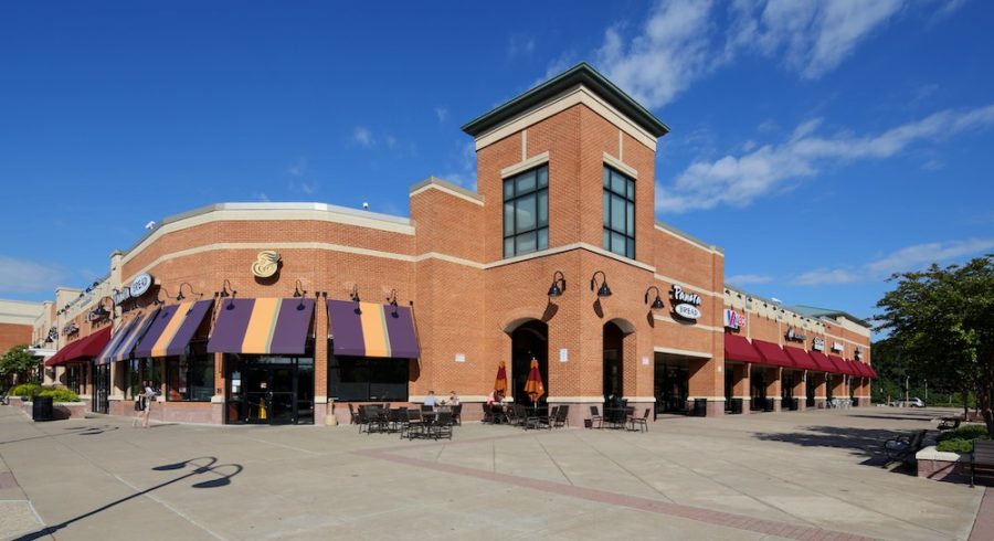 A vibrant view of a diverse shopping center featuring a variety of shops and restaurants.